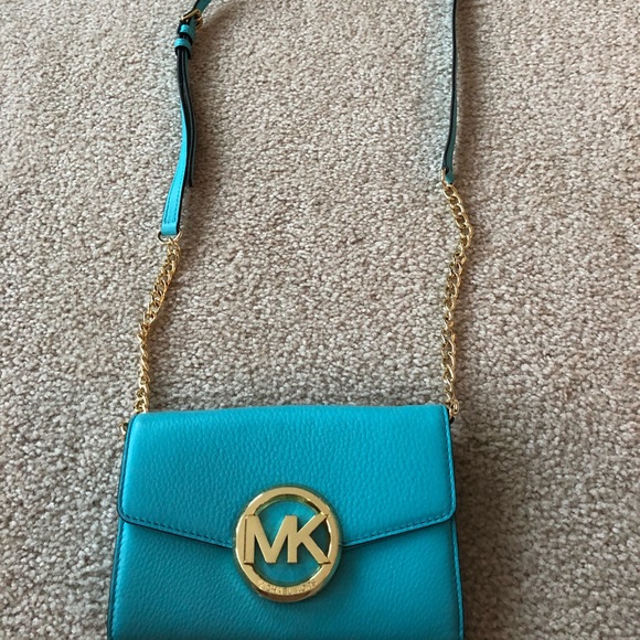 Michael Kors aqua with gold chain and emblem. - Picture 1 of 2